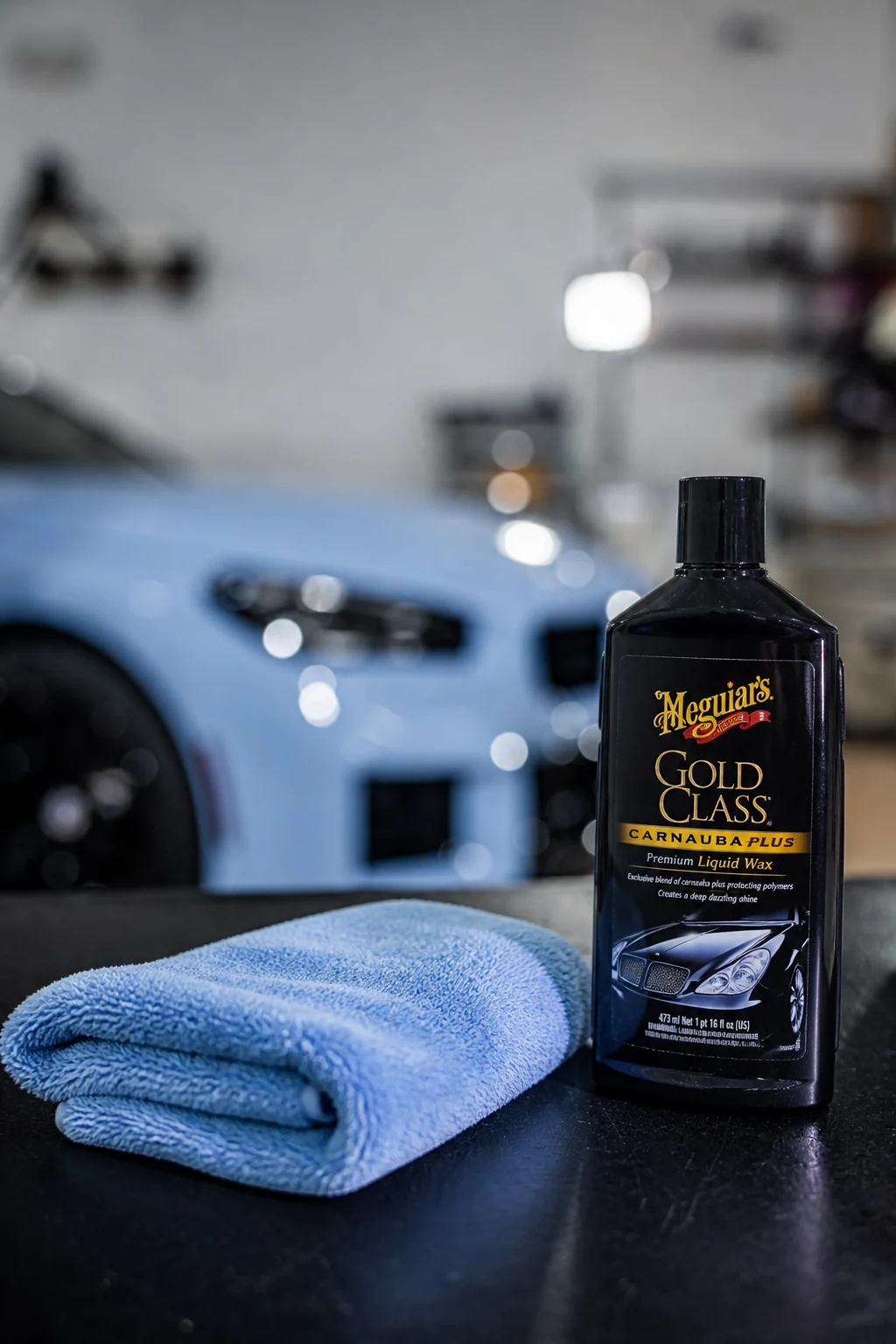 Meguiar's Gold Class hand wax bottle beside a folded microfiber towel