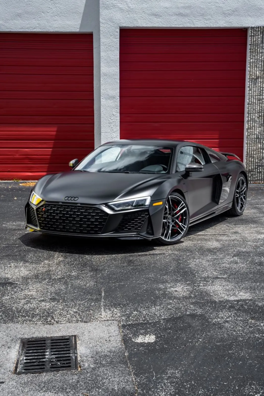 Satin black Audi R8 in a dark studio