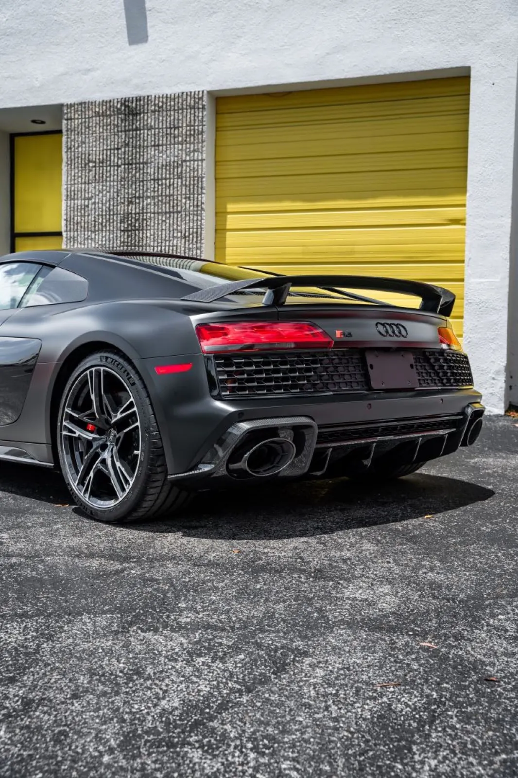 Satin black Audi R8 rear three-quarter view